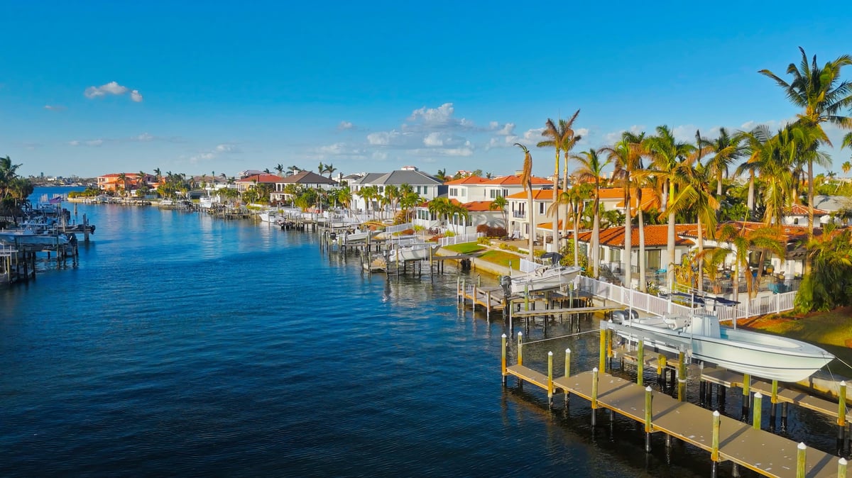 Coastal Florida waterfront homes with palm trees