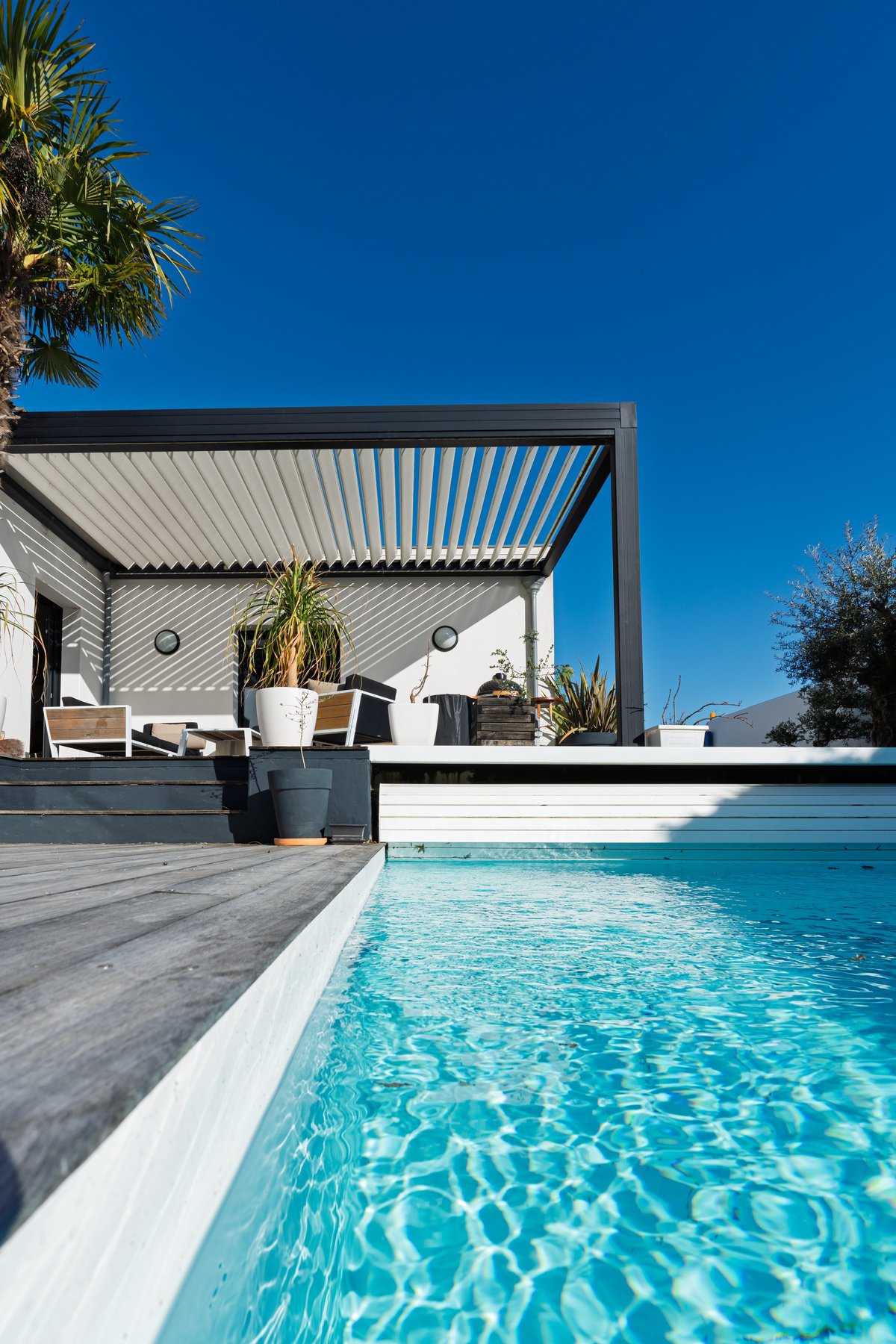 A Florida vacation home with a pool deck and lanai under a clear sky